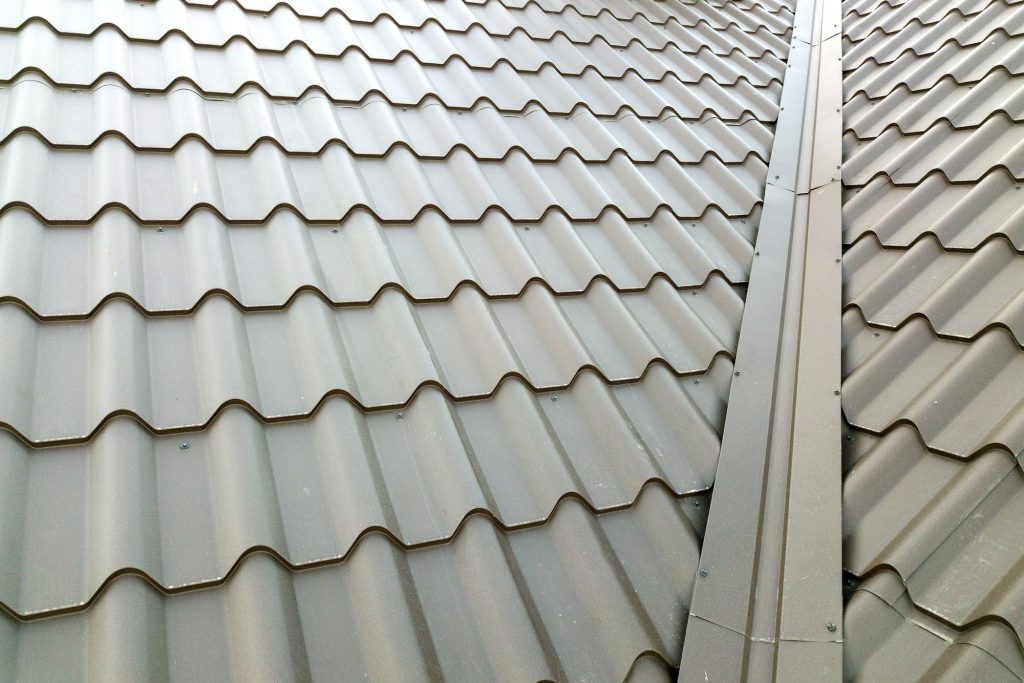 Close up of new house roof structure covered with metal tile sheets